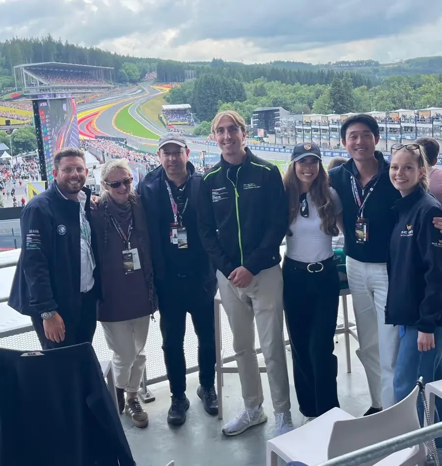Guests with the team on a hospitality terrace above Eau Rouge at Spa
