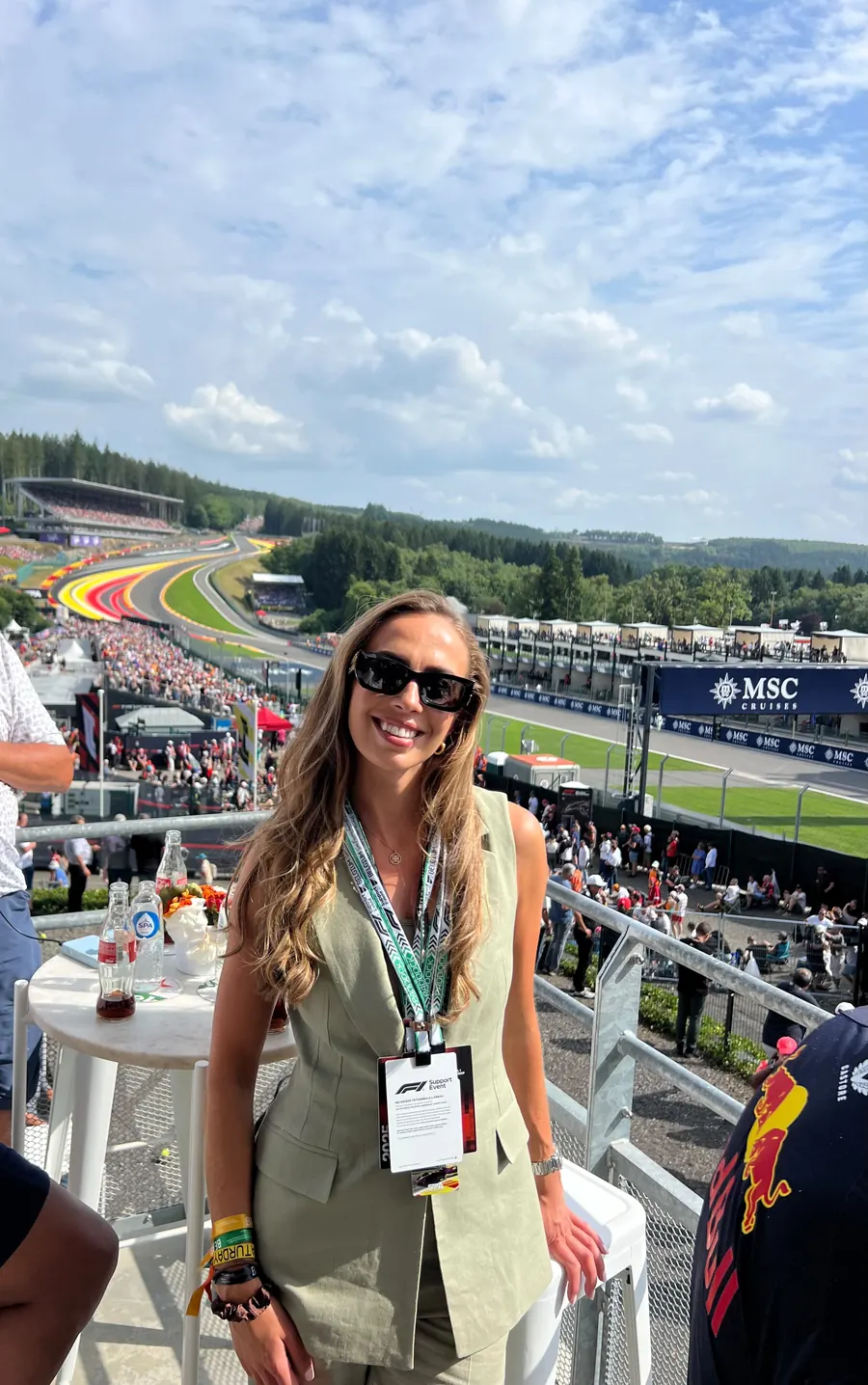 A guest on a hospitality terrace with the Spa circuit behind